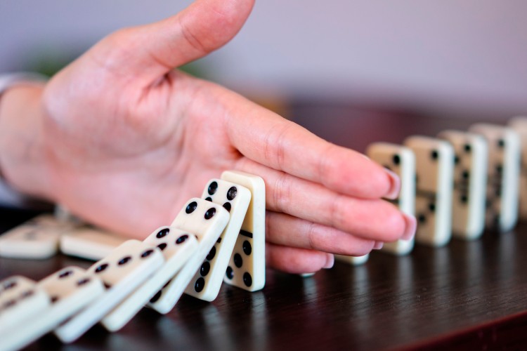 hand-with-dominoes-on-the-table