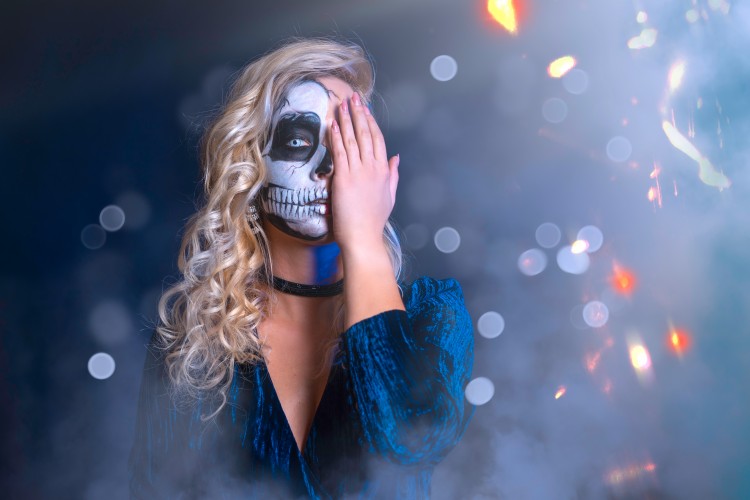 attractive-halloween-girl-with-scary-makeup-posing-on-blurred-background