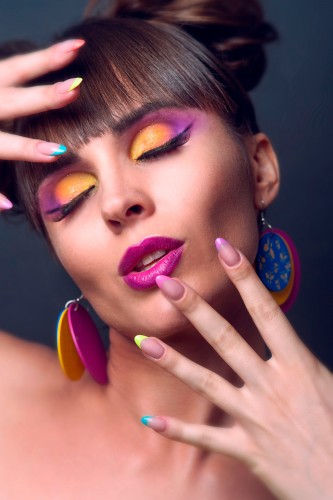 stylish-woman-with-colored-makeup-and-manicure