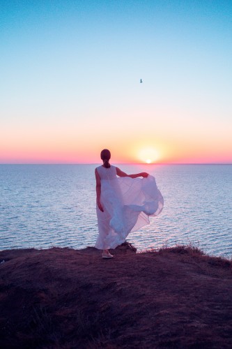 woman-in-white-dress-near-sea-at-the-sunset