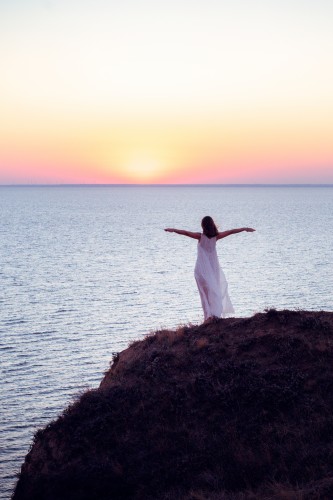 a-young-woman-in-a-white-dress-admires-the-sunset66035