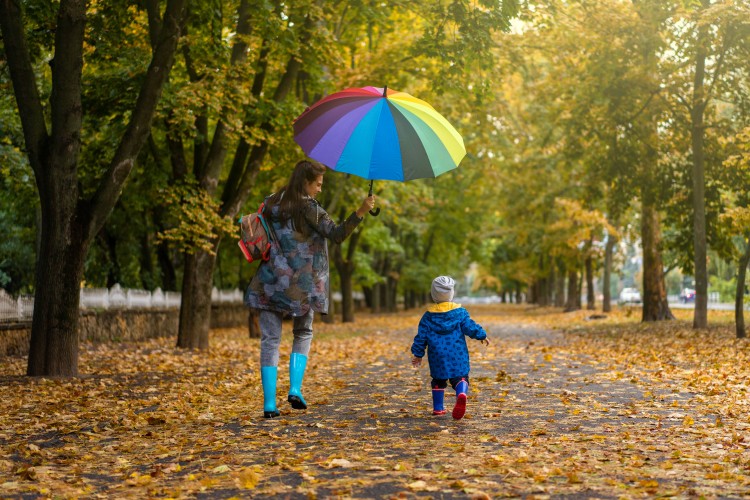 family-walk-under-an-umbrella