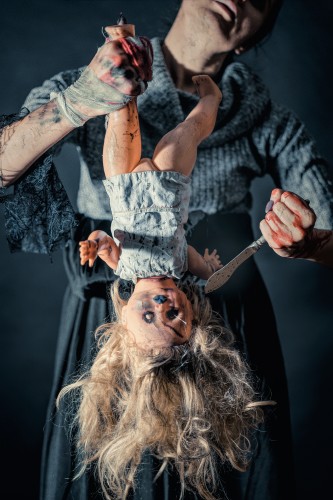 halloween-maniac-holding-doll-and-knife