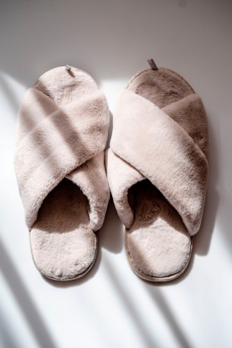 pair-of-fluffy-slippers-under-shadows