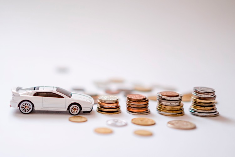 toy-car-and-coins-on-the-light-surface