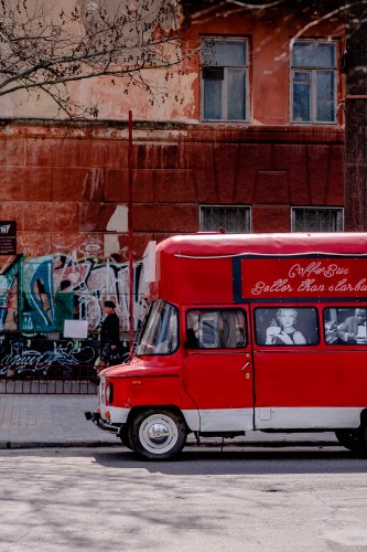 red-coffee-bus-on-the-city-street
