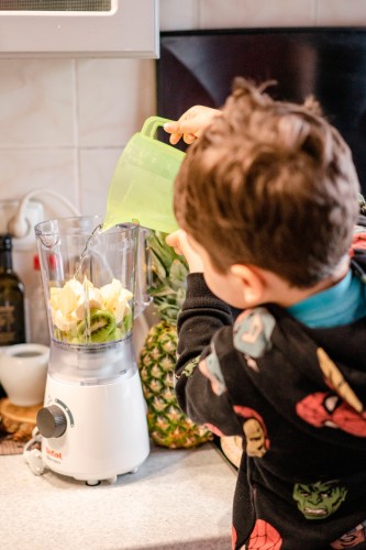 little-boy-pouring-water-into-the-blender-