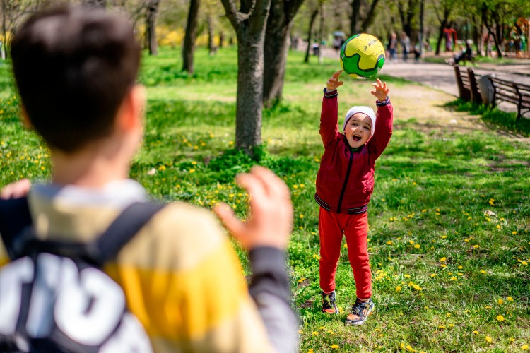 kids-play-with-ball-in-the-park
