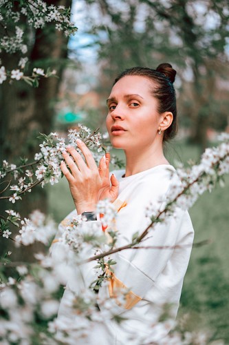 young-woman-near-blossoming-tree