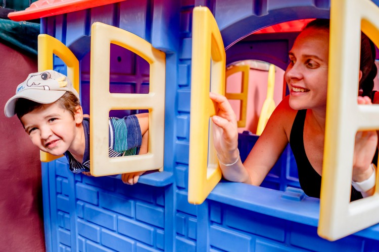 smiling-woman-and-kid-in-the-toy-house