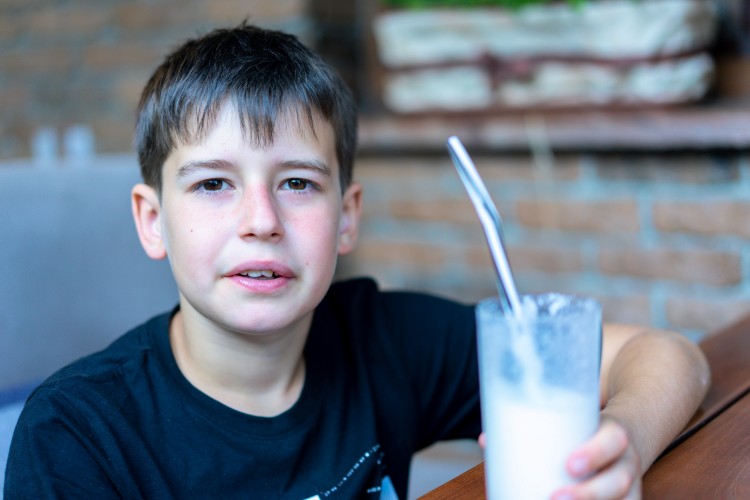 boy-holding-a-glass-of-a-milkshake
