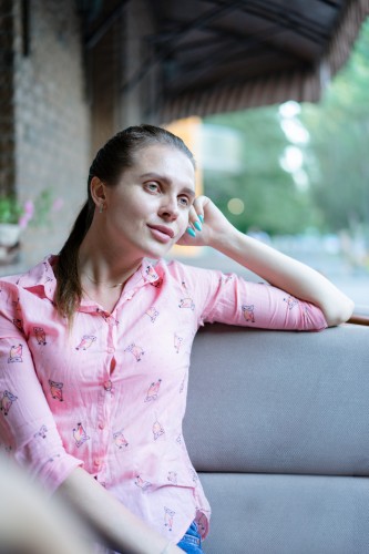 pensive-woman-in-pink-blouse