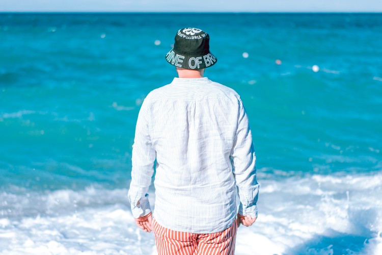 man-in-shirt-and-hat-at-the-sea