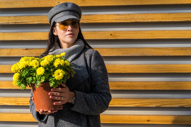stylish-woman-holding-yellow-flowers