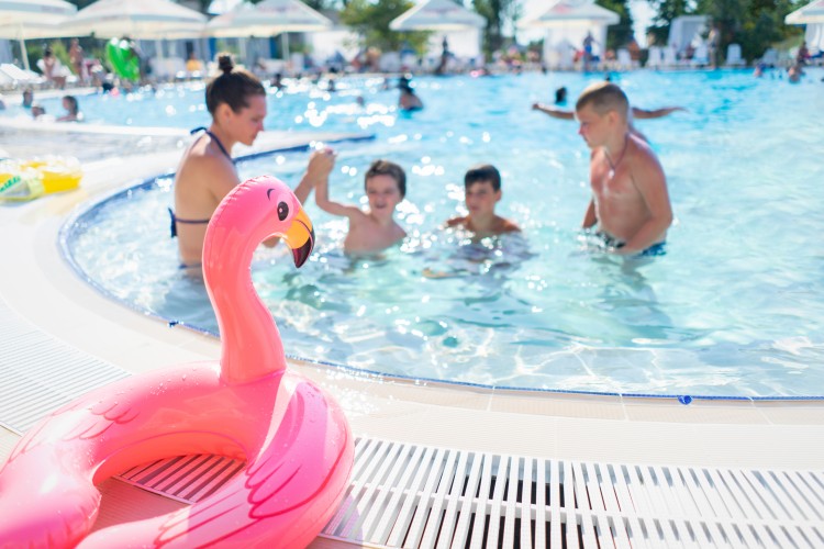 family-having-fun-in-the-pool-at-summer-resort