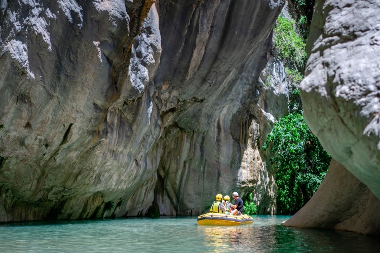 group-of-people-in-helmets-doing-rafting-in-turkish-canyon