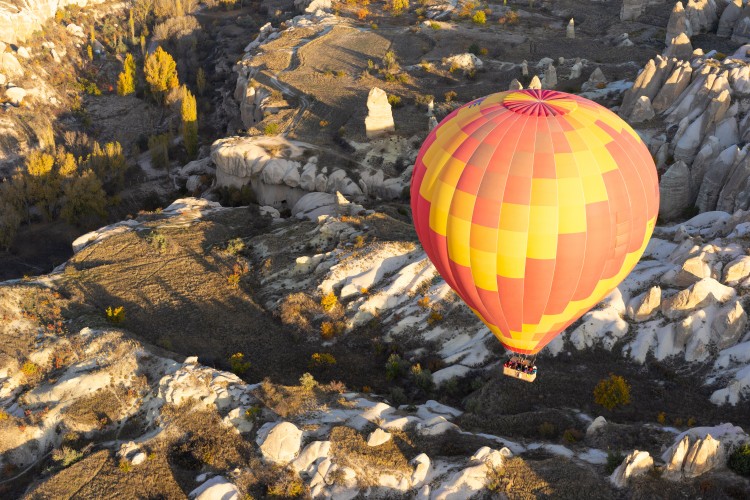 air-balloon-with-people-over-cappadocia-mountains