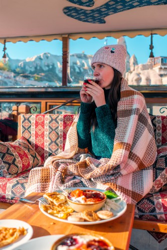 woman-enjoying-traditional-turkish-breakfast