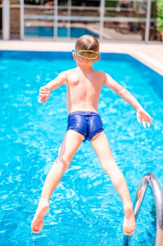 boy-jumping-in-the-swimming-pool