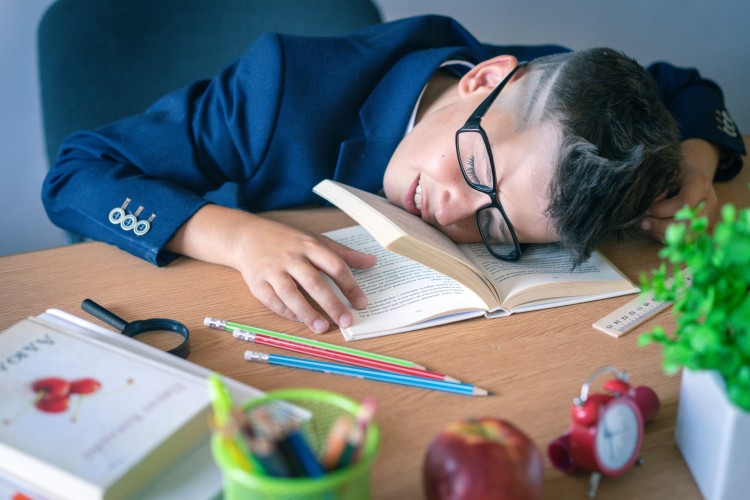 a-schoolboy-in-uniform-fell-asleep-at-a-desk