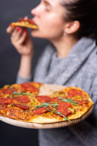 woman-eats-pepperoni-pizza