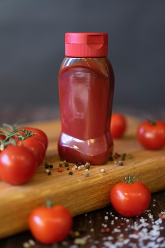 red-ketchup-bottle-on-the-cutting-board