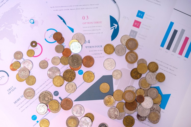 coins-from-different-countries-on-the-background-of-financial-documents