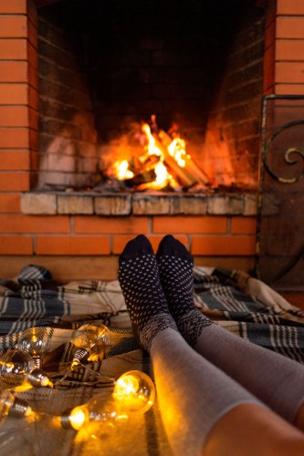 female-legs-in-long-socks-by-the-fireplace