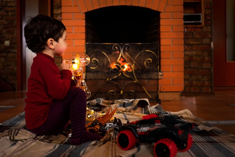 little-boy-by-the-fireplace-