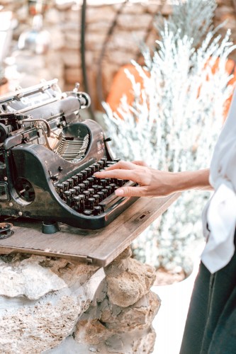 woman-types-on-a-vintage-typewriter