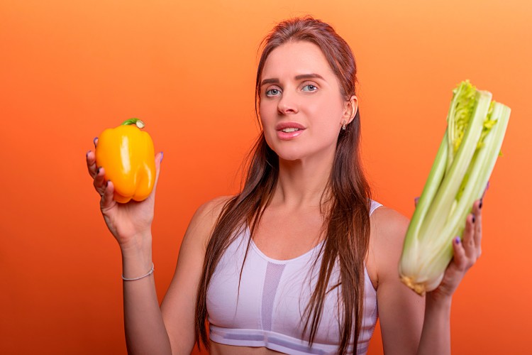 fitness-girl-with-yellow-pepper-and-celery-in-hand