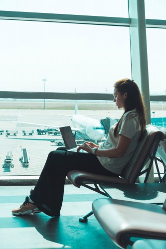 woman-working-with-laptop-in-the-airport
