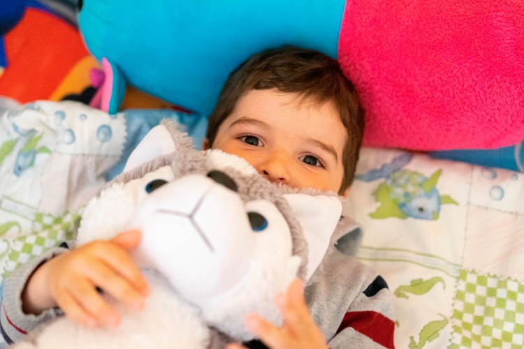 cute-kid-with-toy-in-bed