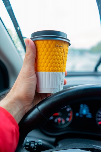 man-with-a-coffee-cup-in-the-car