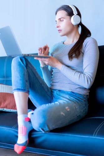 young-woman-with-a-laptop-in-headphones