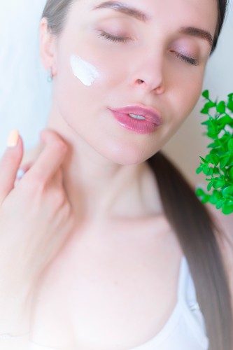 beauty-young-woman-with-cream-on-her-face