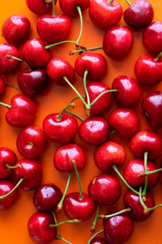 ripe-cherries-on-an-orange-background-