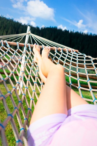 barefooted-woman-chilling-in-hammock-outdoors