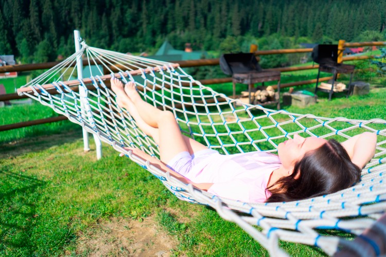 brunette-woman-lying-in-hammock-at-the-vacation-home