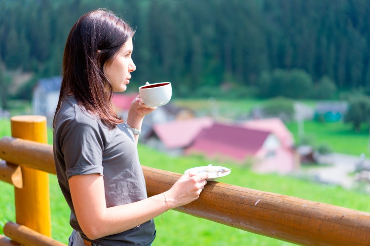 woman-drinks-tea-on-the-nature-background