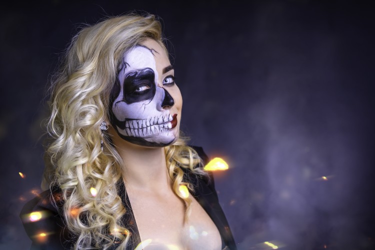 curly-skull-girl-with-halloween-makeup-looking-at-camera