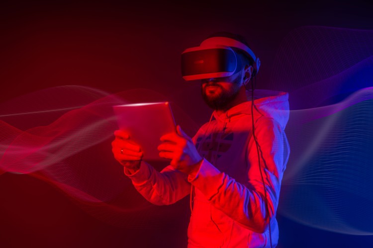 a-man-in-virtual-reality-glasses-with-a-tablet-in-his-hand