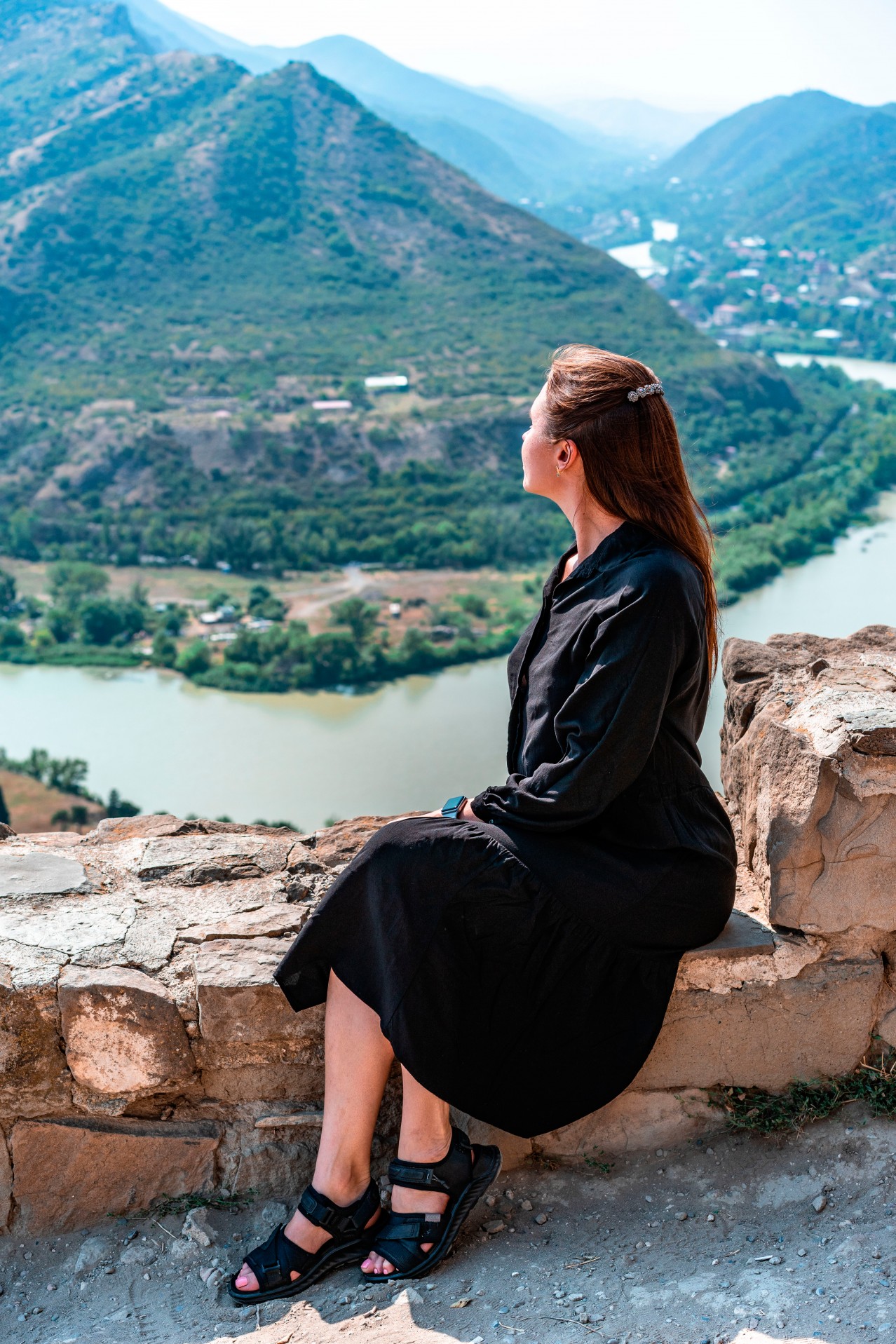 Woman in black dress posing in old Georgian town