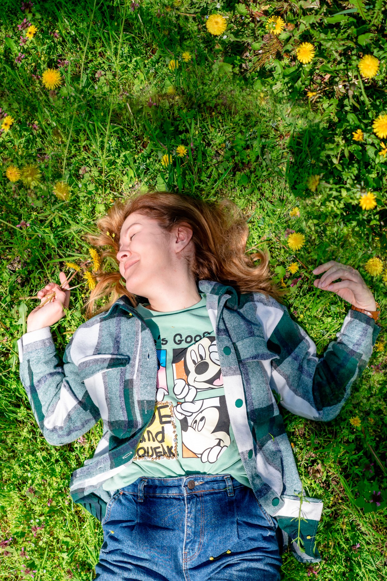 Happy woman lying on the grass