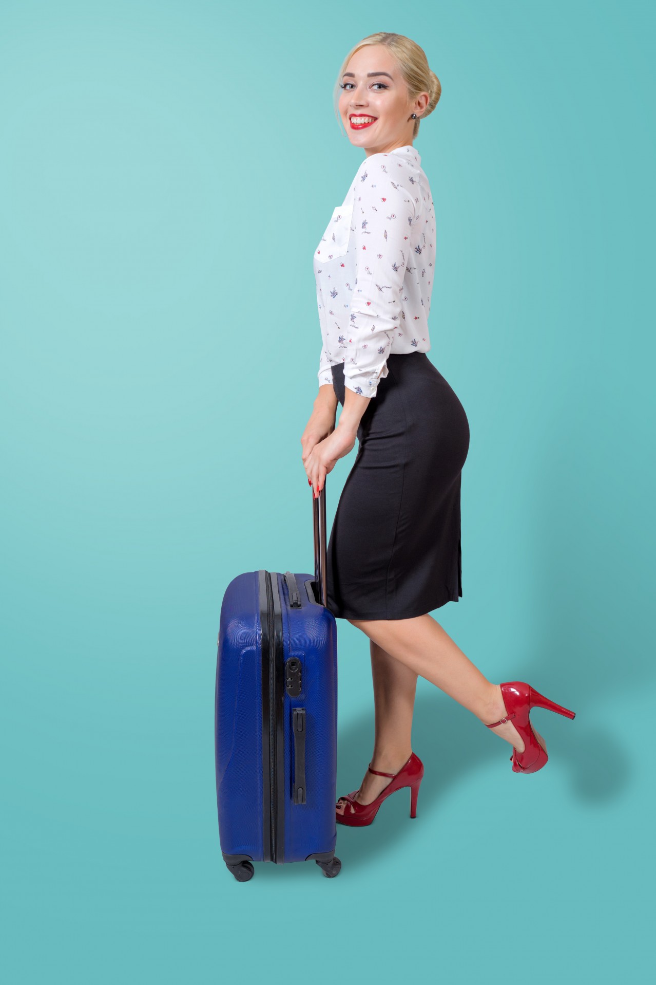 Smiling business woman with travel suitcase