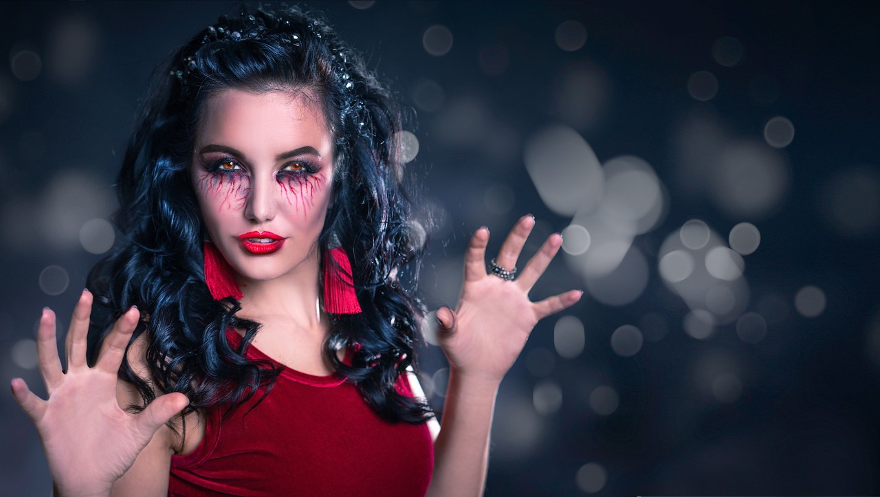 A Passionate Young Brunette Woman  with Halloween Makeup