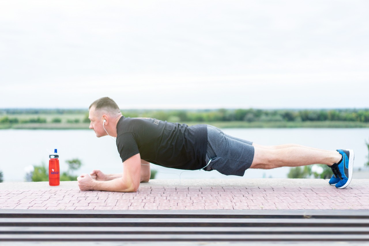 A Handsome Man of Athletic Build Makes the Plank