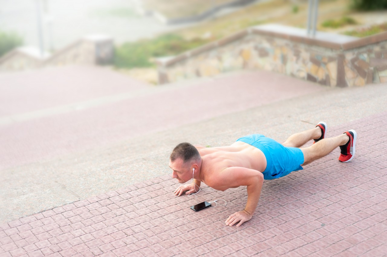 The Athlete Does Push-ups From the Floor