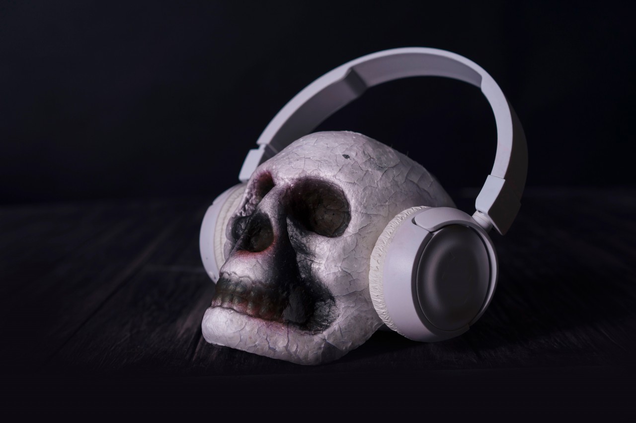 Scary skull in headphones on a black background