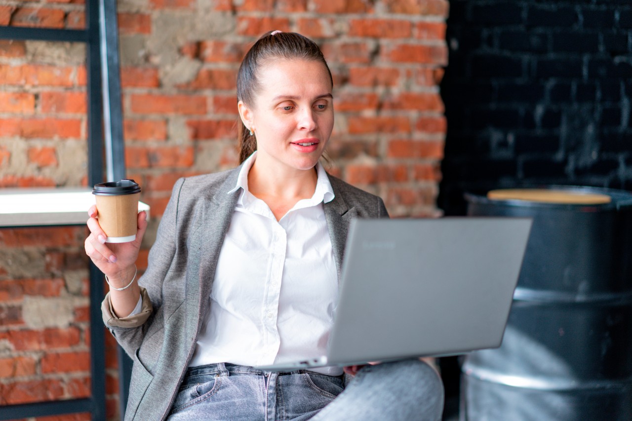 Office Worker with Laptop and Coffee in Hand
